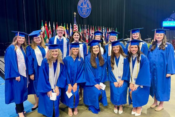 Group picture of students in regalia at graduation ceremony