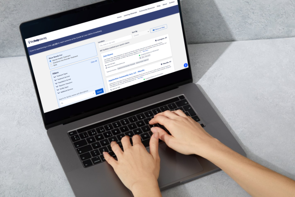 a photograph of someone typing on a laptop