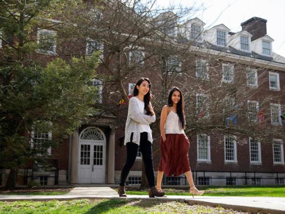 a photograph of two students walking on the University of Kentucky campus